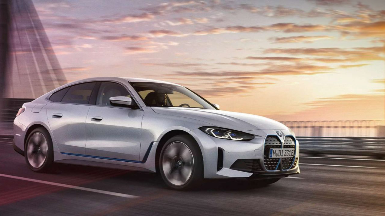 We see a silver BMW saloon car driving over a cantilever bridge.