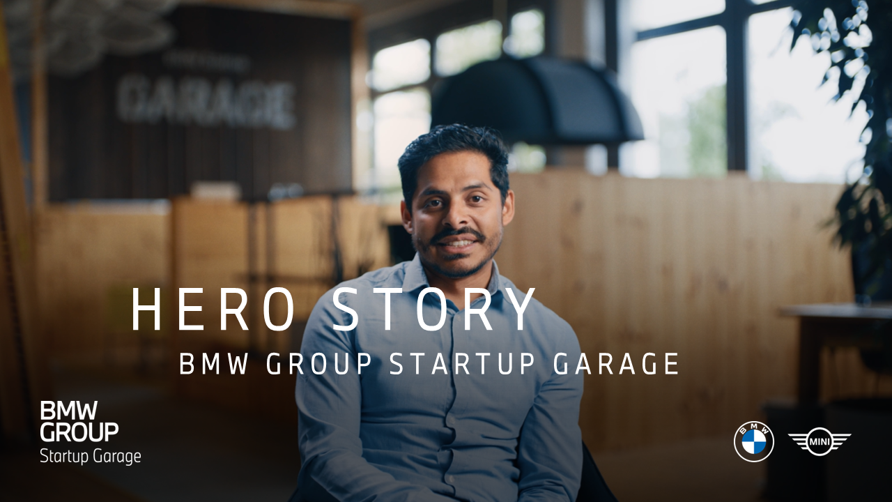Chris, BMW Group employee sitting in an innovative office environment at the BMW Group Startup Garage